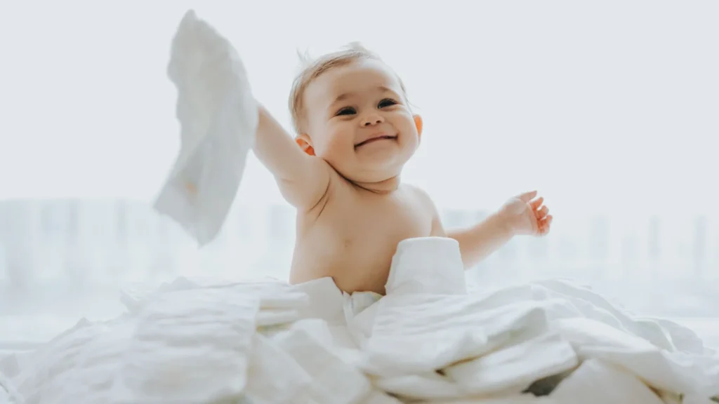 A baby surrounded by diapers